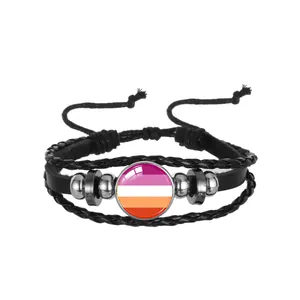 Close-up of black braided leather pride bracelet with colorful striped glass charm.