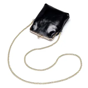 Vintage black leather crossbody phone bag with a gold kiss-lock clasp and curb chain strap