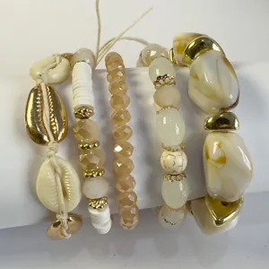 Bohemian stijl kralen armbandenset met gouden schelpen en crème marmeren kralen.