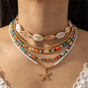 Conjunto de collares bohemios con cuentas, estrella de mar dorada y caracolas blancas