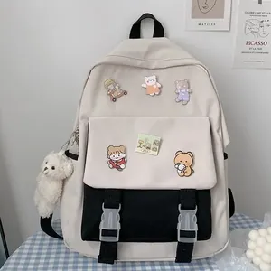 Stylish Korean style cream-white backpack with cute cartoon badges and teddy bear charm