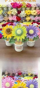 Detail view of colorful handmade crochet sunflower potted plants for creative home decor.