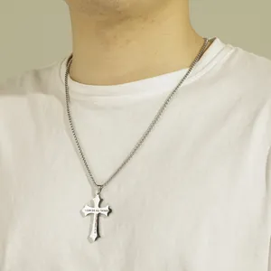 Detail shot of stainless steel cross necklace engraved with Philippians 4:13 verse