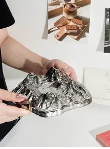 Close-up showing the metallic silver finish of the Fuji mountain shaped crystal ashtray.