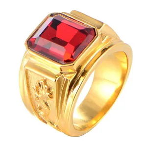 Close-up detail of a masculine gold alloy ring featuring a large red rectangular gemstone