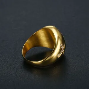 Close-up of gold-plated stainless steel signet ring with crystal cross detail for men