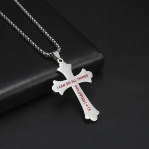 Close-up of stainless steel cross pendant with Philippians 4:13 scripture engraving.
