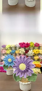 Close-up of handmade crochet sunflower potted plant with detailed wool texture