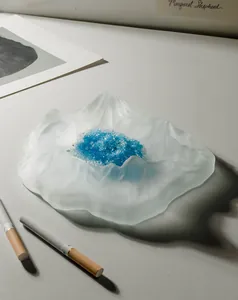 Detailed macro view of frosted crystal glass Mt. Fuji iceberg ashtray with blue crystals