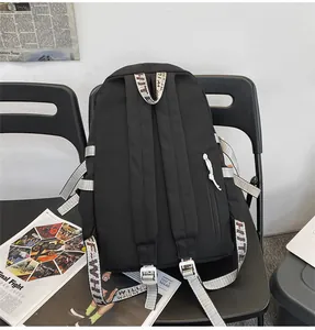 Detail view of large capacity black student backpack with industrial style straps
