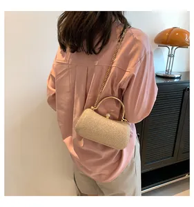 Elegant gold glitter evening clutch bag shown from a back perspective on a model