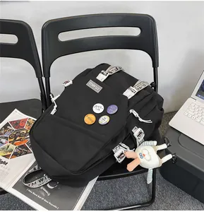 Detailed view of black backpack with unique industrial straps and bunny charm.
