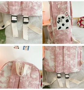 Detail view of pink tie-dye backpack showing straps, side pocket and top handle.