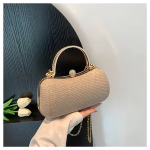 Elegant sparkly champagne gold evening clutch with crystal handle and chain strap.