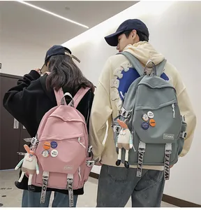 A back view of student models wearing pink and grey large capacity laptop backpacks
