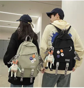 Trendy large capacity school backpack with decorative straps and cute rabbit pendant