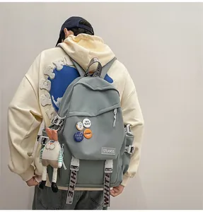 Grey blue large capacity student backpack with cute decorative pins and rabbit charm