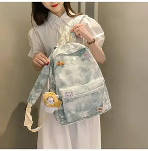 Close-up of a cute green tie-dye backpack with cartoon patches worn by a model