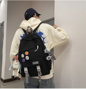 Rear view of a large black student laptop backpack featuring industrial style alphabet straps.