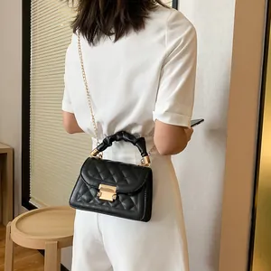 Classic black quilted small square bag with chain strap and scrunchie handle