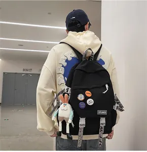 Detailed back view of a black large-capacity canvas backpack with cute bunny pendant