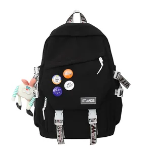 Black large capacity student laptop backpack with decorative patches and plush toy