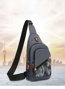 Close-up of a gray men's leisure sling bag with camouflage detail and orange accents