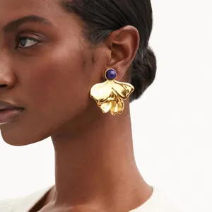 Elegant bold irregular fan-shaped 18K gold earrings with blue natural stone detail
