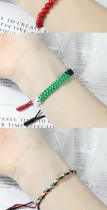 Detail of handmade woven bracelets featuring Palestine flag colors shown on wrist