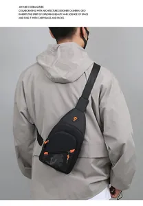 Detailed macro view of a black men's chest bag with orange accents and camo pattern