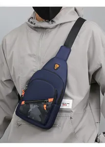 Navy blue men's crossbody chest bag with camo detail shown worn on a casual hoodie