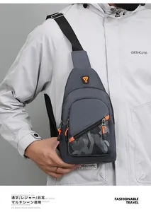 Detailed view of grey men's sling bag with camouflage pocket and orange accents.