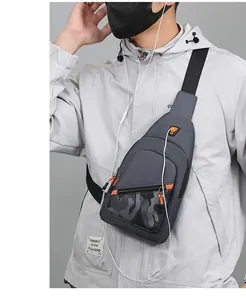 Close-up of a grey chest bag worn by a model, showing orange zippers and texture