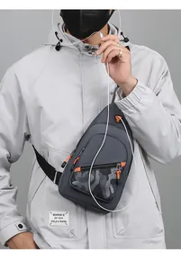 Detailed view of grey men's sling bag featuring camouflage pattern and headphone port