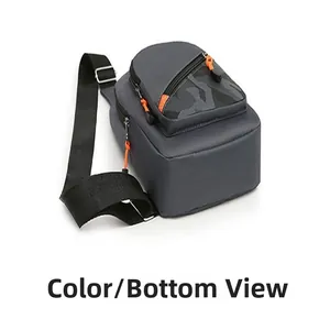 Bottom view of modern men's crossbody chest bag with orange accents and camo pocket