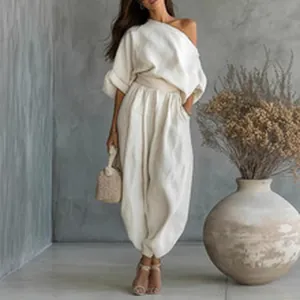 Elegant white off-shoulder lounge set with loose long sleeve top and matching pants.