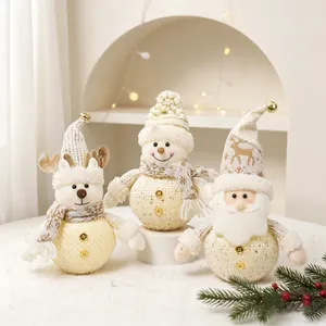 Set of three cozy white knitted Christmas plush dolls: Santa, Snowman, and Reindeer.