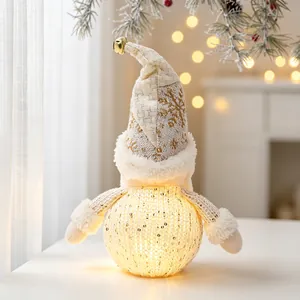 Close-up of glowing Christmas gnome ornament with sequins and bell details