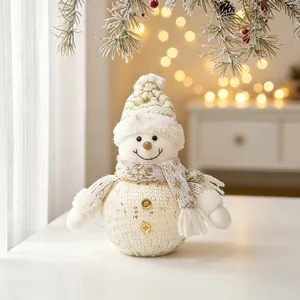 Detailed macro shot of a white knitted Christmas snowman doll with warm festive bokeh lights