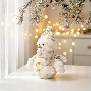 Detail view of a glowing fabric Christmas snowman doll with warm internal LED lights