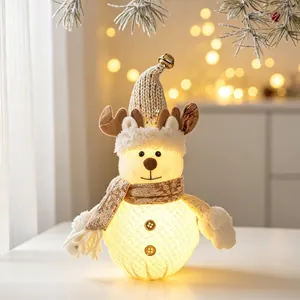 Close-up of glowing reindeer doll with knit hat for Christmas decor