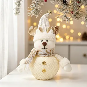 Detail view of a knitted Christmas snowman plush with sequined antlers and bell hat