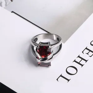 Vintage stainless steel ring with large rectangular red gemstone and cross cage setting