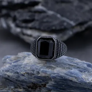 Bague vintage pour hommes en acier inoxydable avec pierre noire rectangulaire et anneau texturé.