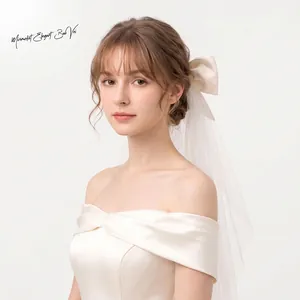 Detailed view of the elegant white double-layered tulle wedding veil with bow
