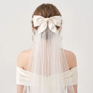 Detailed back view of an elegant white double-layer bridal veil featuring a large satin bow