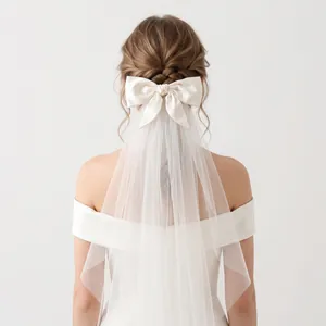 Elegant white double-layer bridal veil with large satin bow for wedding photography
