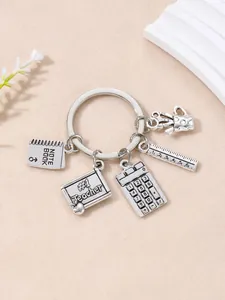 Silver teacher-themed keychain with charms like a calculator and #1 Teacher blackboard.