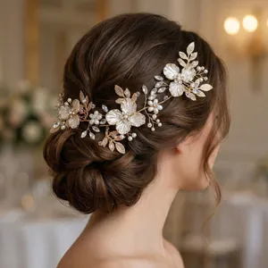 Elegant handmade bridal hair comb with gold leaves, white pearls and sparkling rhinestones