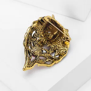 Detailed macro back view of the vintage gold wolf head brooch showing sturdy pin mechanism